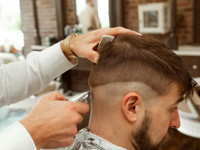 A barber cutting a client's hair in a barbershop